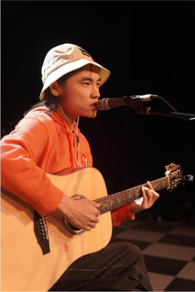 Past KEPMA Cup contestant singing with guitar